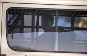 Perth airport, 1998: Sadiq Elmi crossing the tarmac in a security van in Australia’s second attempt to deport him to Somalia, in defiance of CAT’s interim request.  The deportation was disrupted by civil society action and abandoned. (photo: Ross Swanborough)