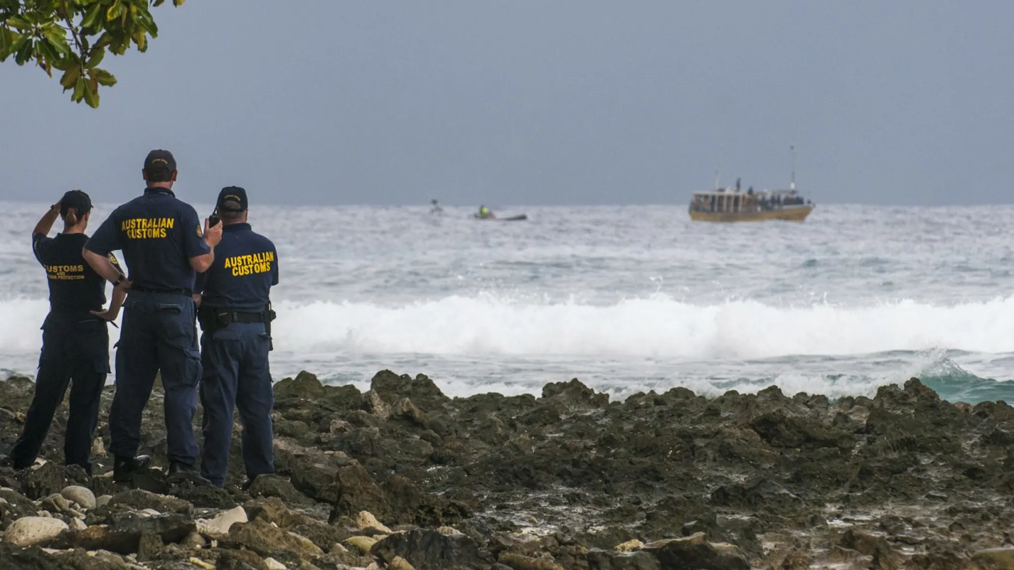 Australian customs officials watch Sri Lankans approaching Cocos (Keeling) Islands by boat in 2016. Mr S.L. reached the Cocos Islands in the Indian Ocean, over 2,000km from the Australian mainland, in 2012; this is not his boat. (image: Karen Willshaw, Sydney Morning Herald)